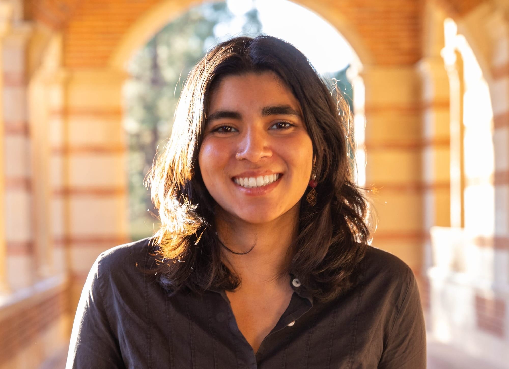 Climate activist and UCLA student Zara Ahsan smiles while on the college campus.