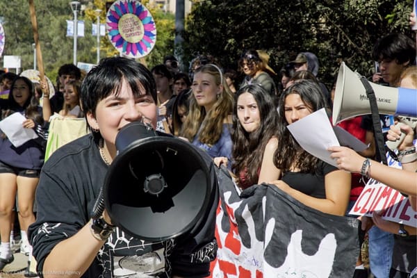 A student with a bullhorn takes part in the "Make Polluters Pay" school walkout in October 2025 to sway lawmakers to back legislation to "Make Polluters Pay" for environmental disasters. 